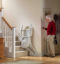 senior man calling a stairlift using a remote control